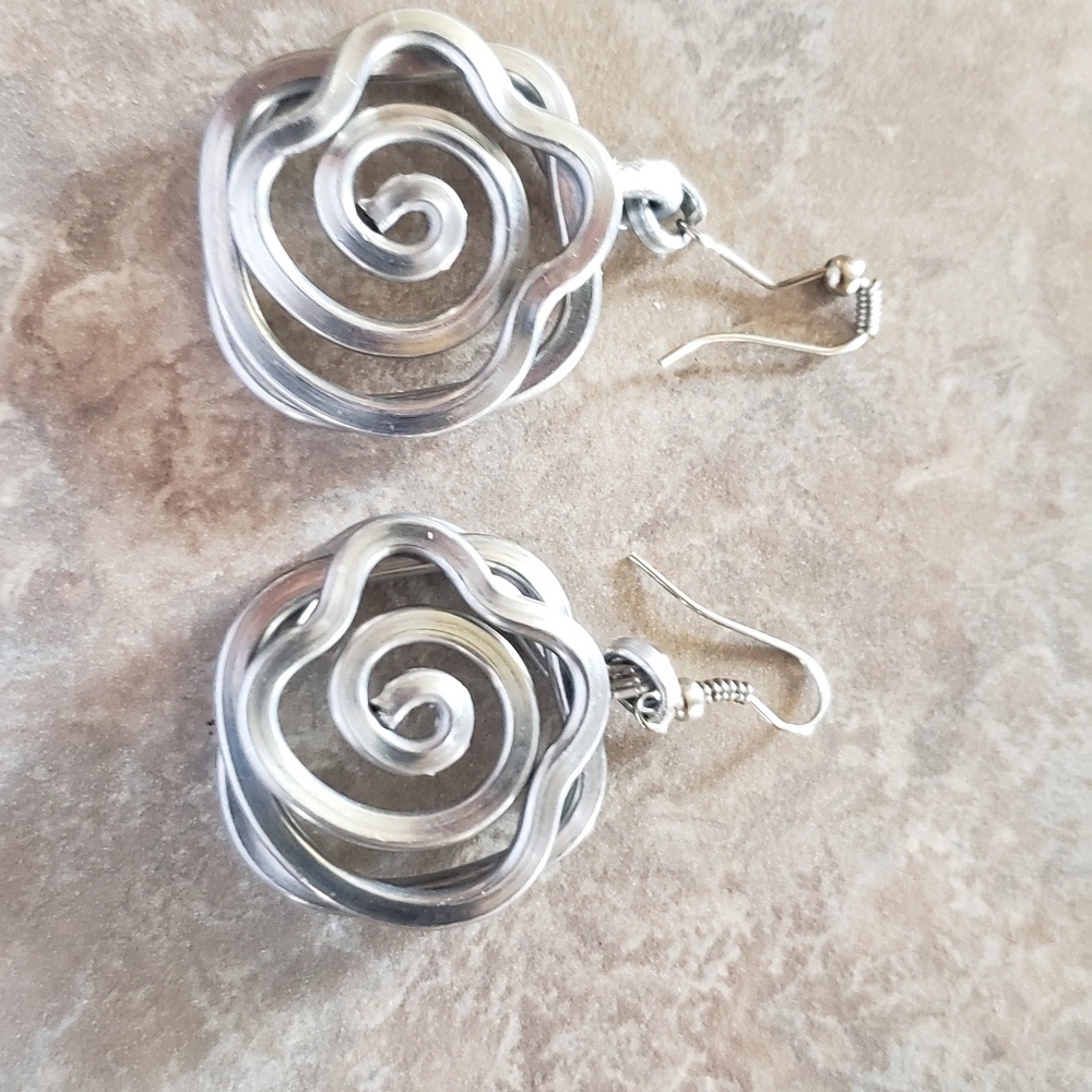 Nice silvery earrings. Cool shape. Nautilus like.